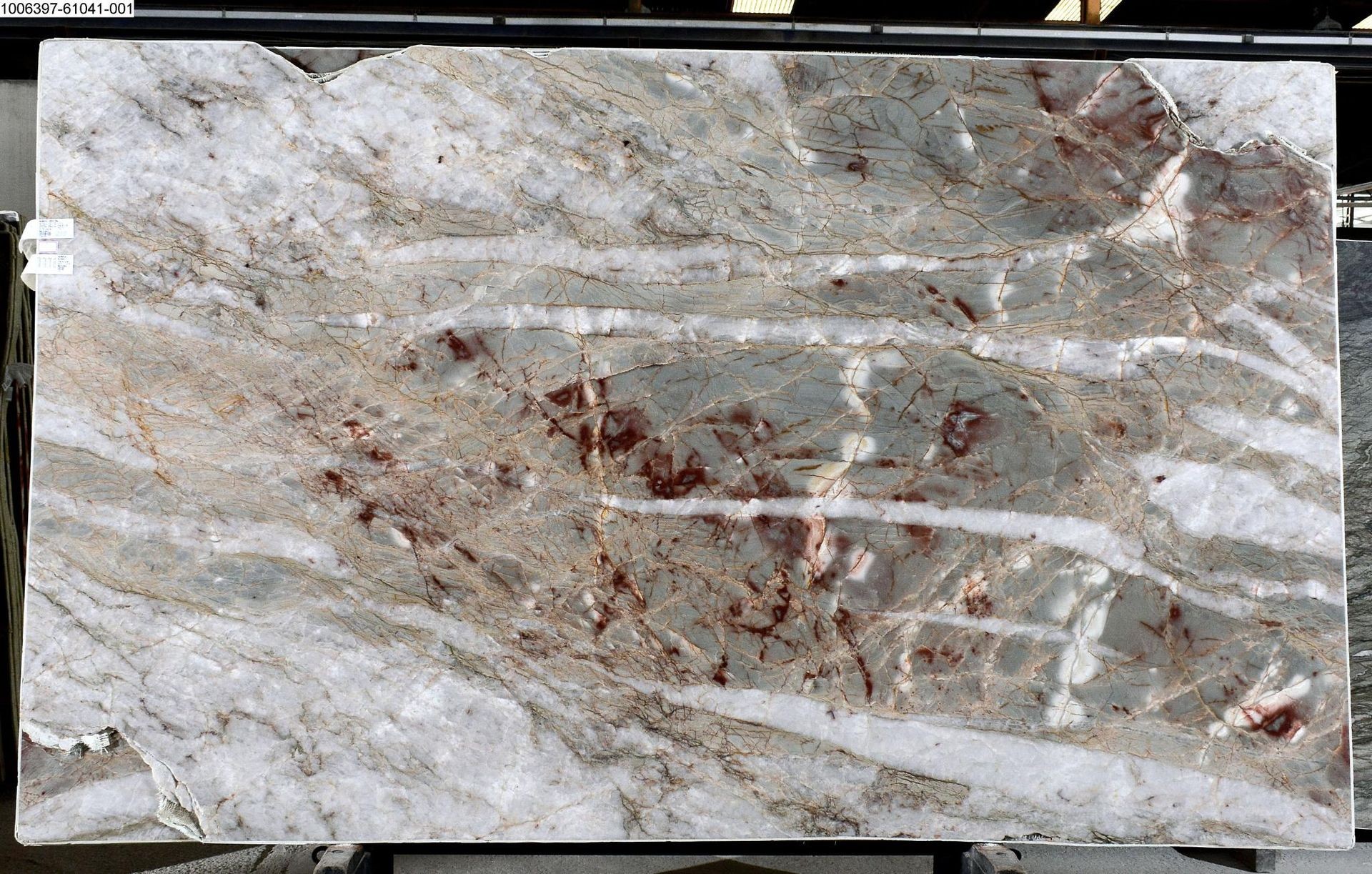 Quartzite with crystal and red tons, background beige